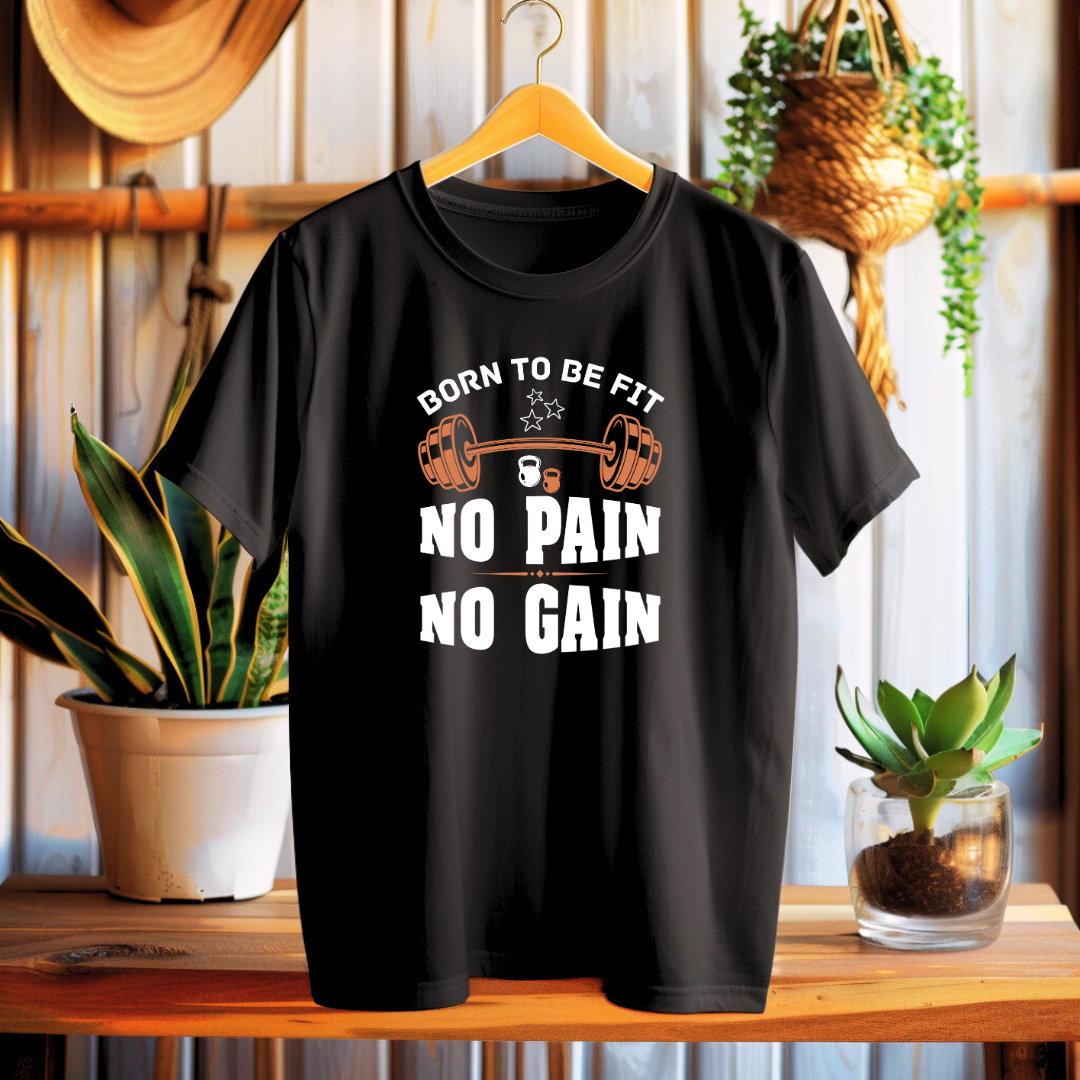Black t-shirt with fitness-themed text on a wooden surface with plants in the background