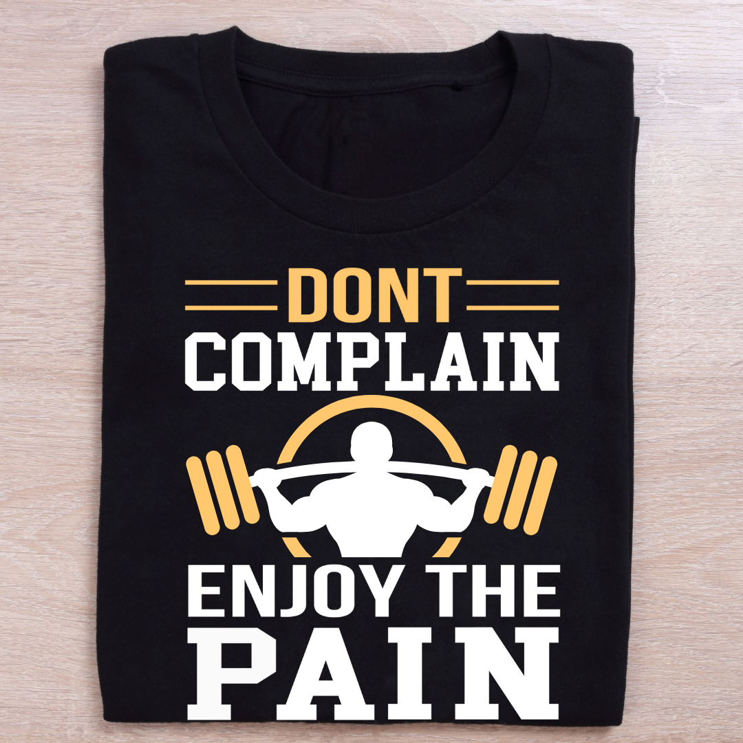 Black t-shirt with motivational text and graphic on a wooden surface