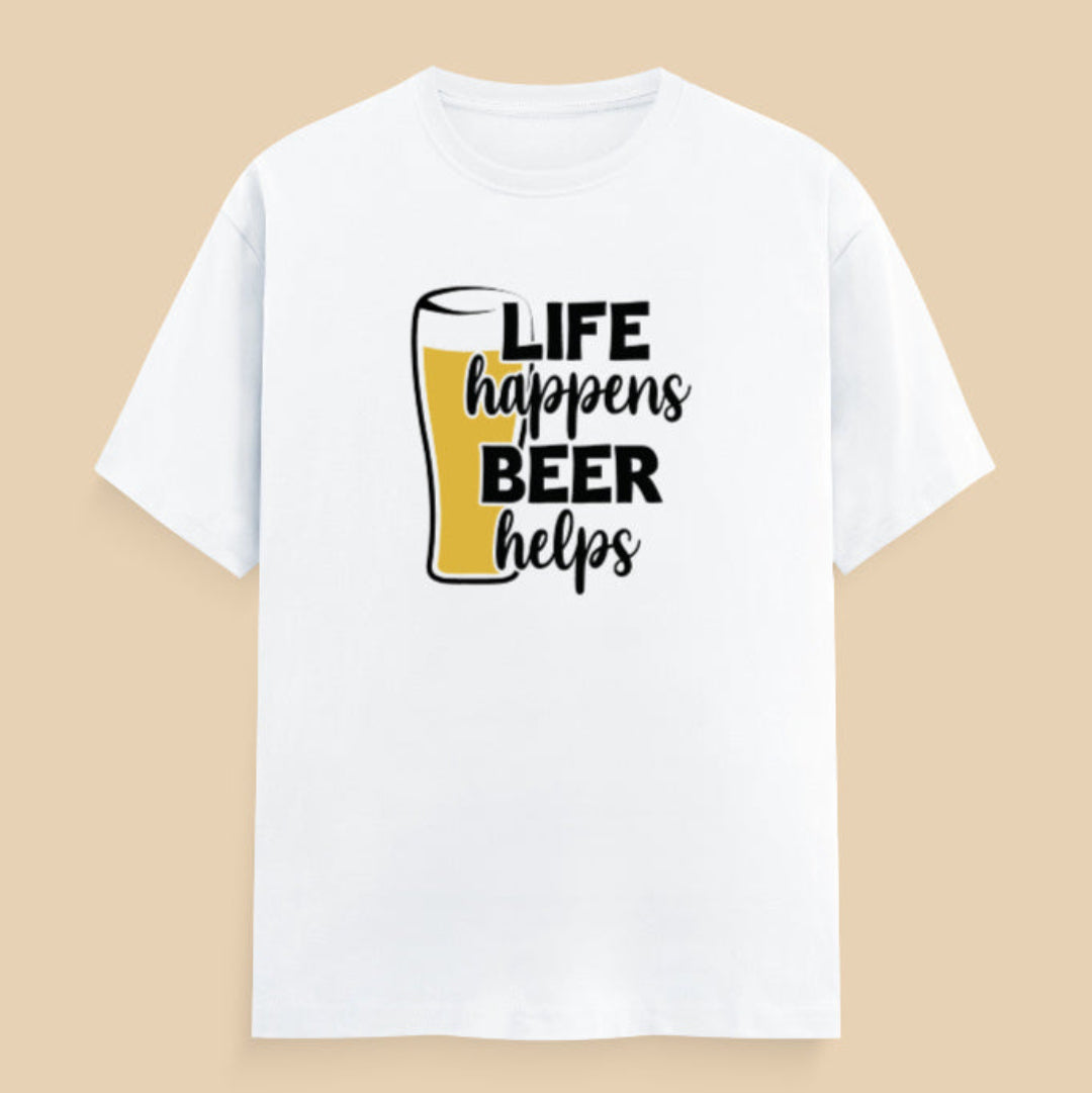 White t-shirt with 'Life happens, Beer helps' text on a wooden surface
