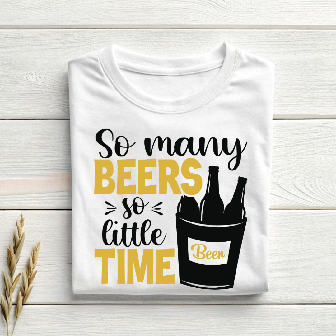 White t-shirt with 'So many beers so little time' text and beer bottle graphic on a wooden surface.