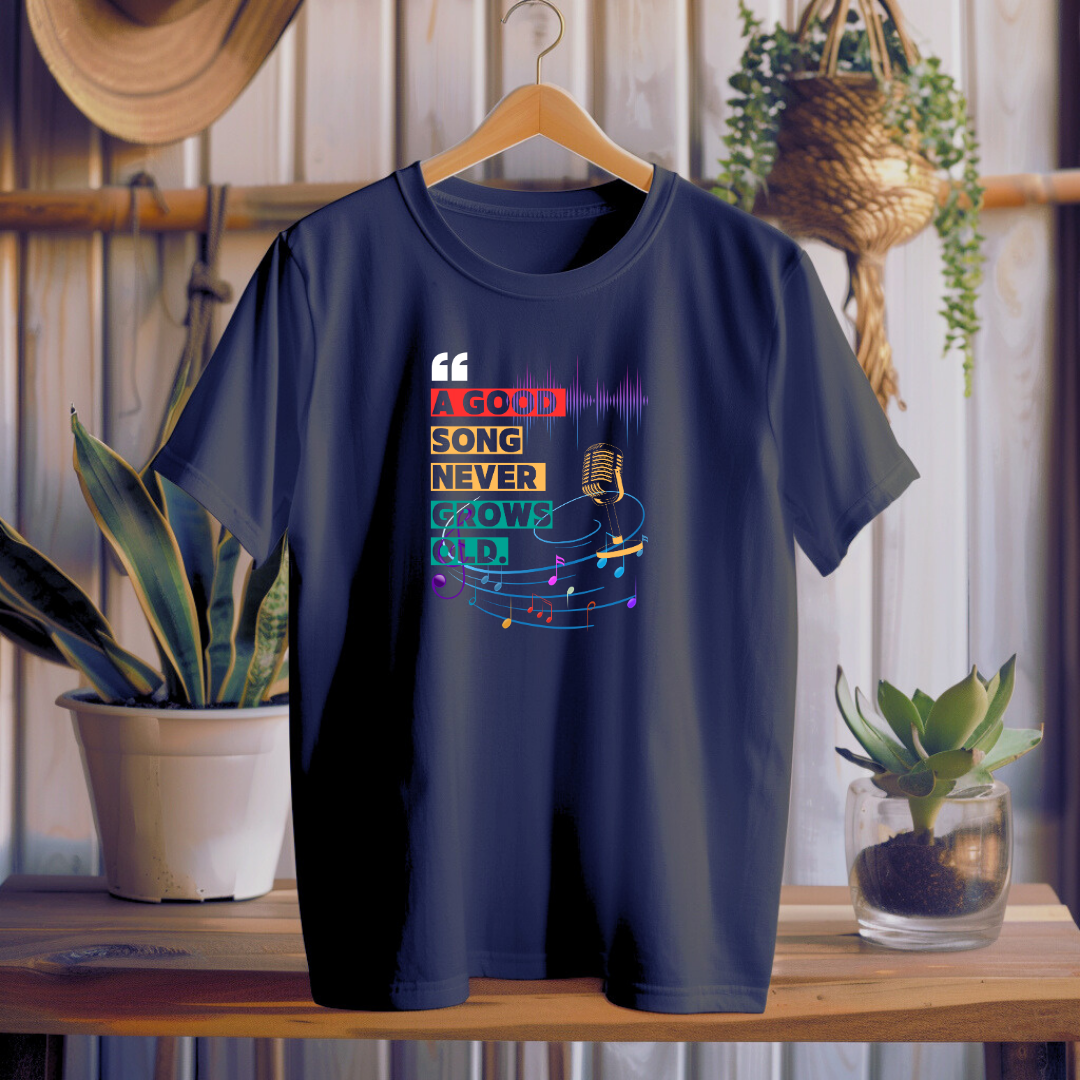 Navy Blue t-shirt with colorful graphic design on a wooden table with plants in the background