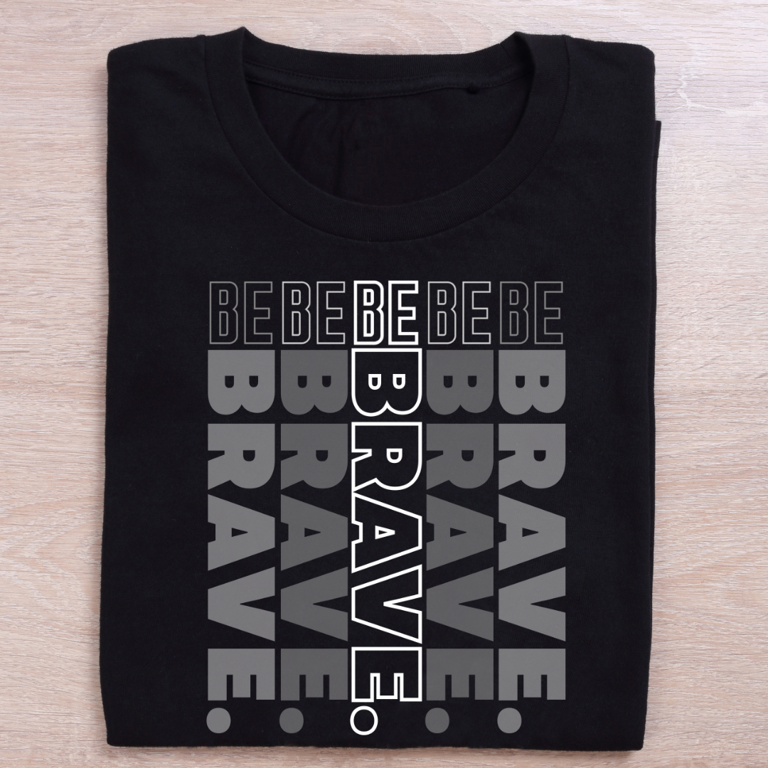 Black t-shirt with 'BEBE BRAVE' text design on a wooden surface