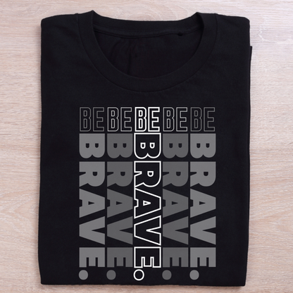 Black t-shirt with 'BEBE BRAVE' text design on a wooden surface