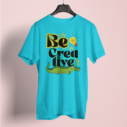 Turquoise t-shirt with 'Be Creative' text and alligator graphic on a pink background