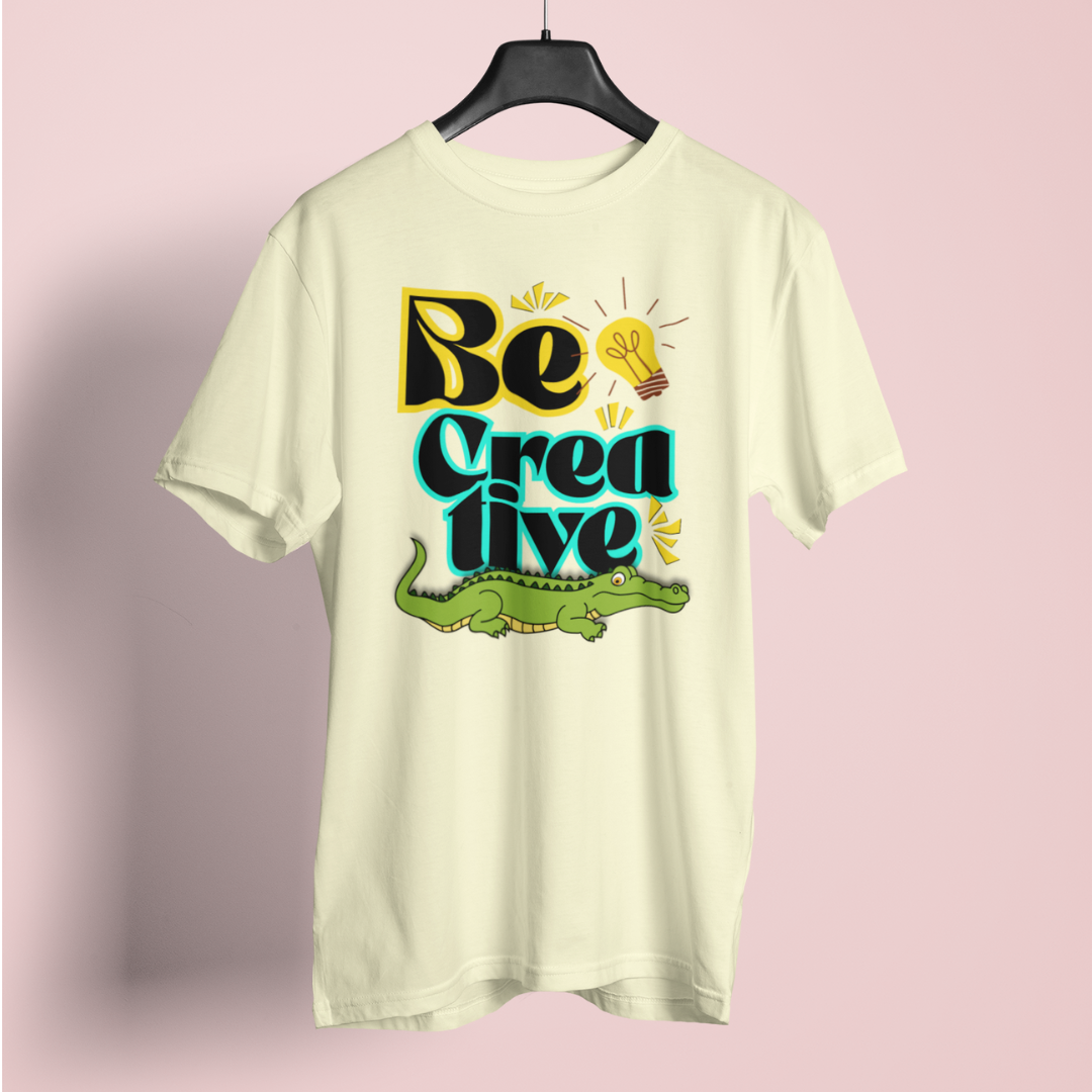 Light-colored t-shirt with 'Be Creative' text and alligator graphic on a pink background
