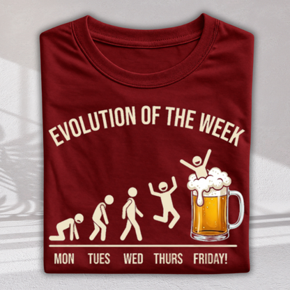 A folded maroon crewneck t-shirt with a graphic print that reads 'EVOLUTION OF THE WEEK' and 'MON TUES WED THURS FRIDAY!'. The graphic shows a beer mug with a celebrating figure on top, replacing the traditional human evolution sequence.