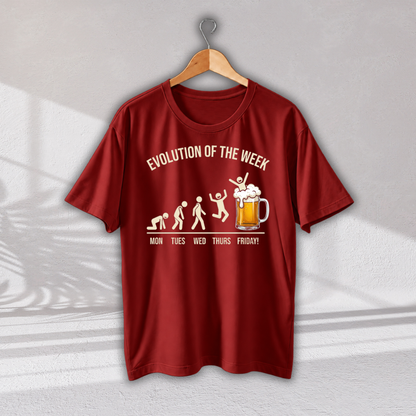 A red short-sleeve t-shirt hanging on a wooden hanger against a light gray wall. The shirt features a white graphic print depicting the evolution of humans with a beer mug at the end, captioned 'EVOLUTION OF THE WEEK' and 'MON TUES WED THURS FRIDAY!'.
