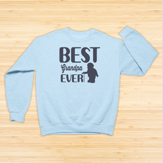 Light blue sweatshirt with 'Best Grandpa Ever' text on a wooden surface