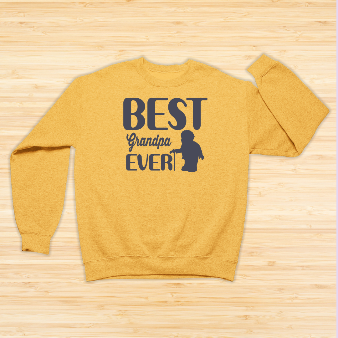 Yellow sweatshirt with 'Best Grandpa Ever' text on a wooden surface