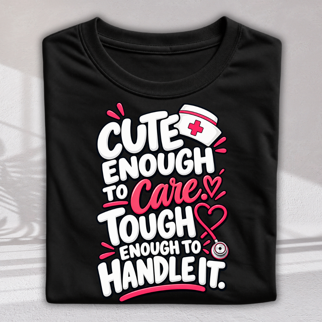 A black folded graphic T-shirt on a light gray background. The shirt features a colorful text design that reads 'CUTE ENOUGH TO Care.