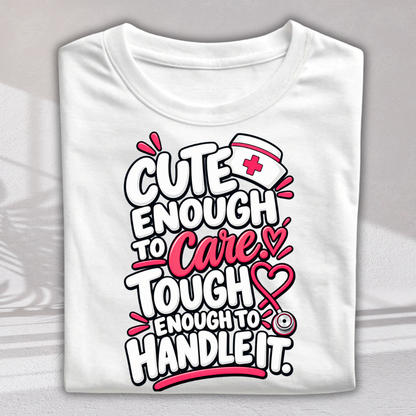A folded white short-sleeve t-shirt with a colorful graphic print on the front. The graphic features the text 'CUTE ENOUGH TO Care.