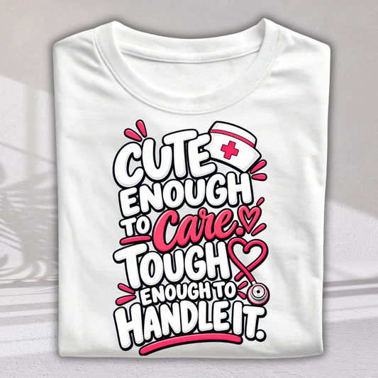 A folded white short-sleeve t-shirt with a colorful graphic print on the front. The graphic features the text 'CUTE ENOUGH TO Care.