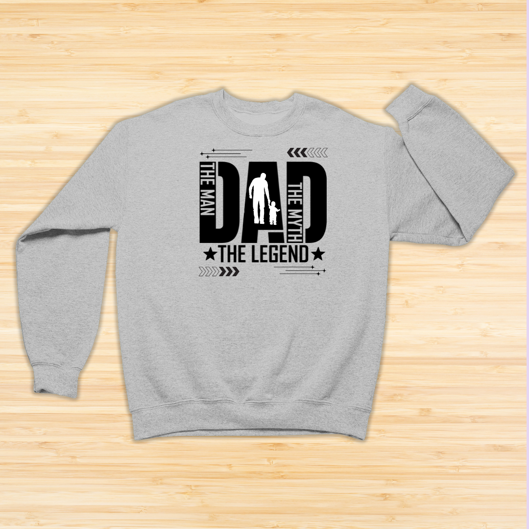 Gray sweatshirt with 'The Man, The Myth, The Legend' text design on a wooden surface