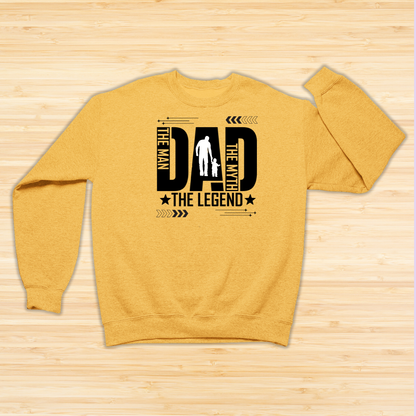 Yellow sweatshirt with black text design on a wooden surface