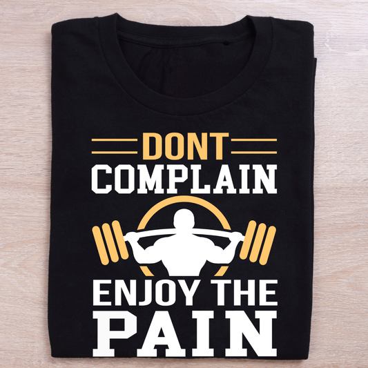 Black t-shirt with motivational text and graphic on a wooden surface