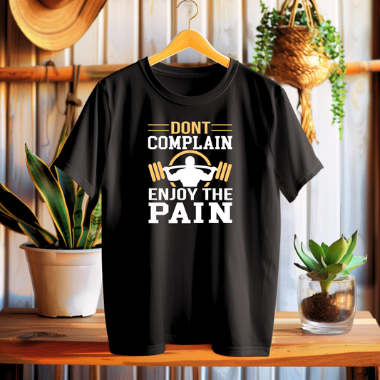 Black t-shirt with motivational graphic on a wooden surface with plants in the background