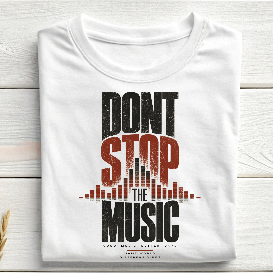 A folded white t-shirt with a distressed graphic print reading 'DONT STOP THE MUSIC' in black and red, styled on a light wood plank background.