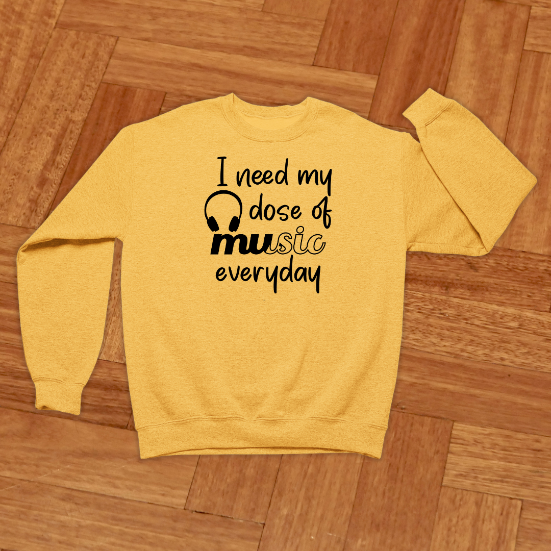 Yellow sweatshirt with text on a wooden floor