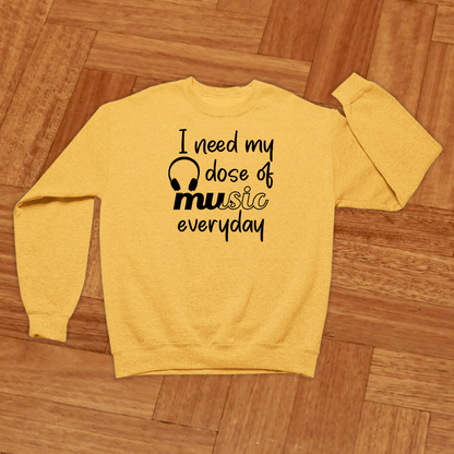 Yellow sweatshirt with text on a wooden floor