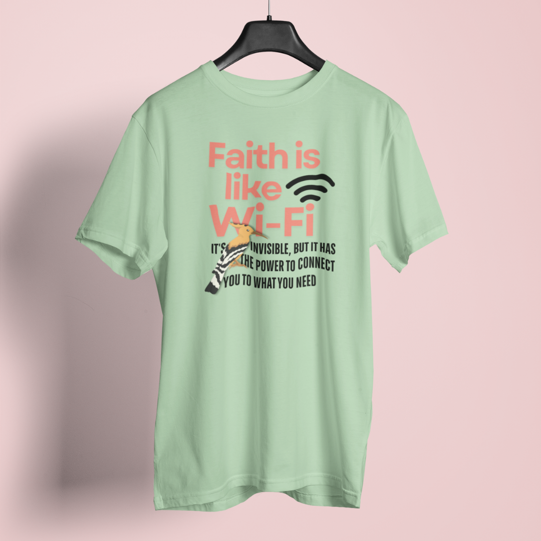 Light green t-shirt with text design on a pink background