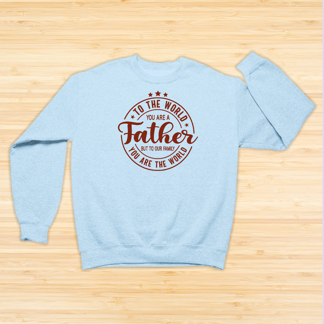 Light blue sweatshirt with red text on a wooden surface