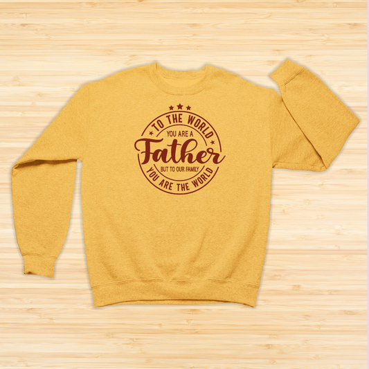 Yellow sweatshirt with text on a wooden surface