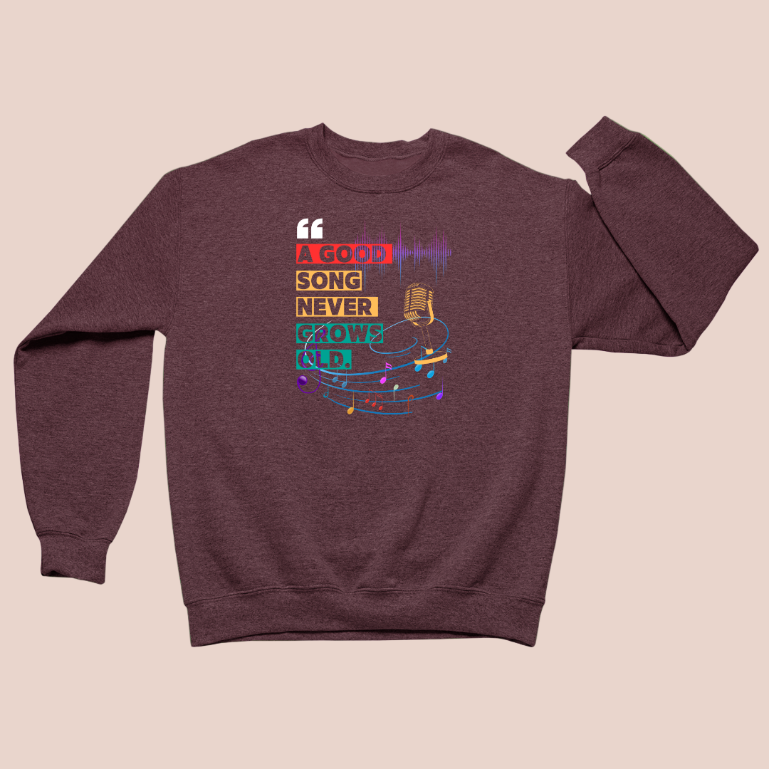 Maroon sweatshirt with colorful graphic design on a green background