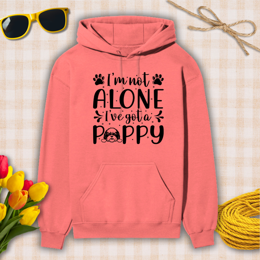 Coral hoodie with text 'I'm not alone, I've got a poppy' on a checkered background with sunglasses, tulips, and twine.