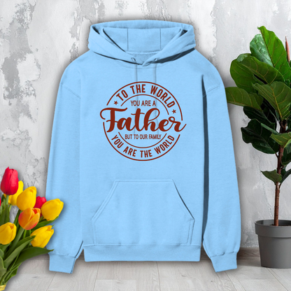 Light blue hoodie with red text on a gray surface with flowers and a plant.