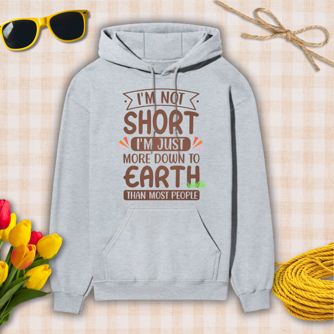 Gray hoodie with humorous text design on a checkered background with sunglasses, flowers, and twine.