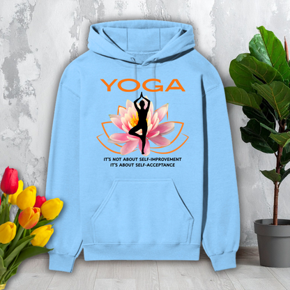 Light blue hoodie with yoga design and text, placed on a surface with flowers and a plant in the background.