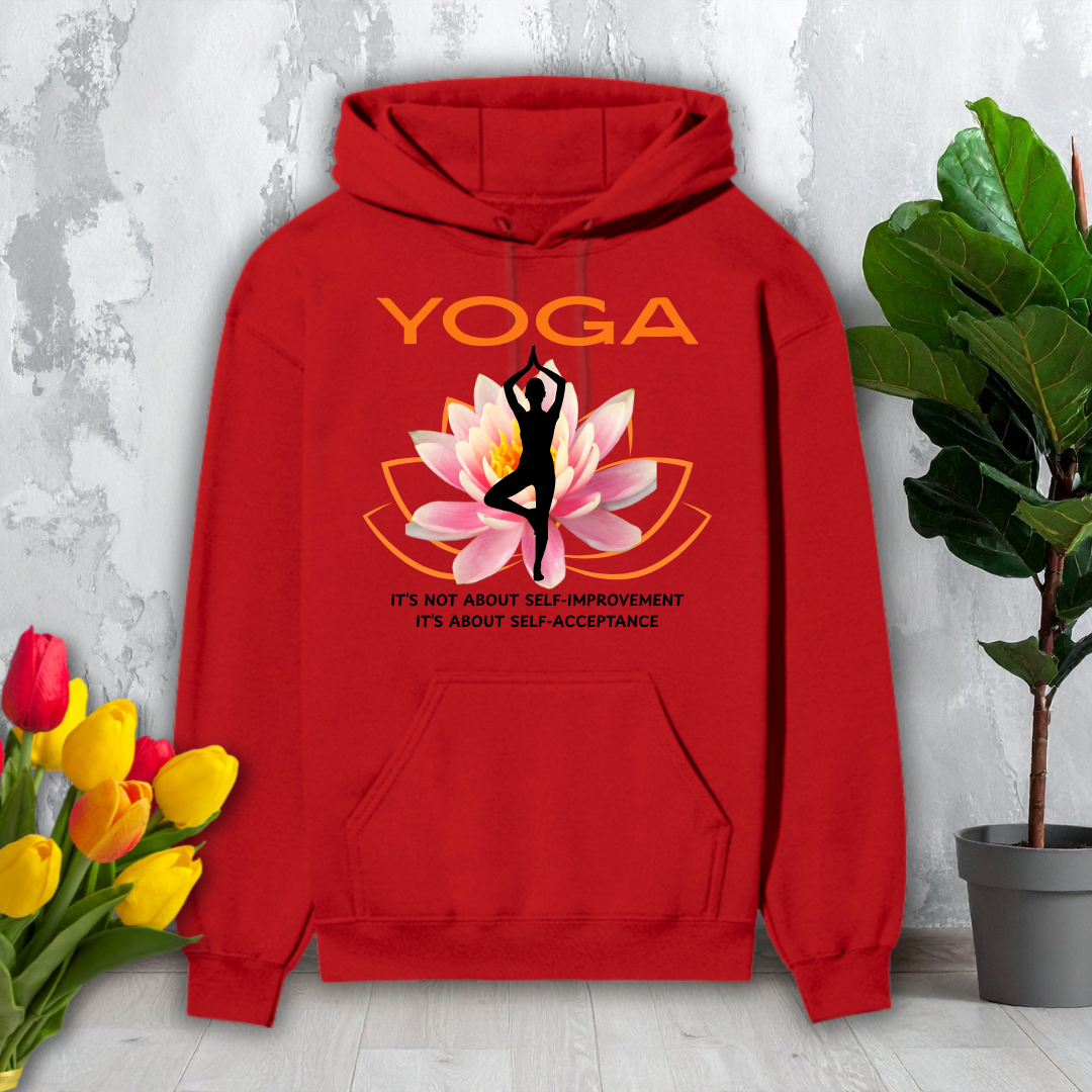 Red hoodie with yoga design featuring a lotus flower and text, placed on a light wooden floor with flowers and a plant in the background.