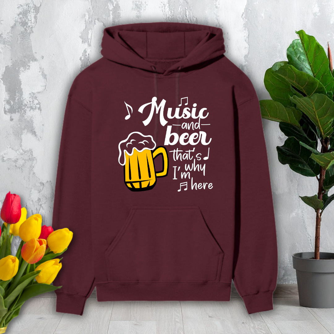Maroon hoodie with 'Music and beer that's why I'm here' text and beer mug graphic on a light gray background with flowers and a plant.