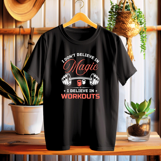 Black t-shirt with motivational quote on a wooden table with plants in the background