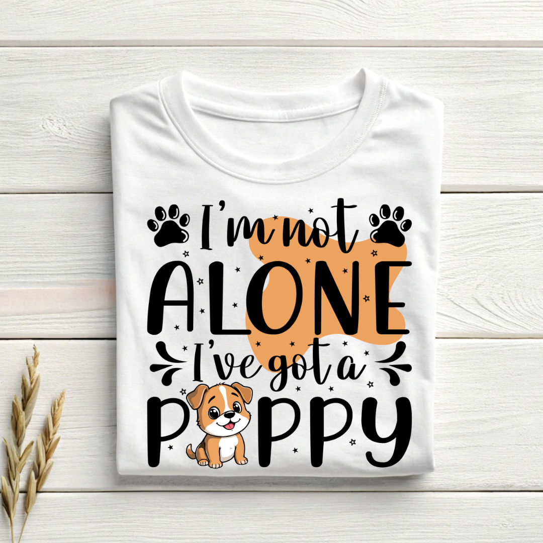 White t-shirt with a dog-themed graphic and text on a wooden surface