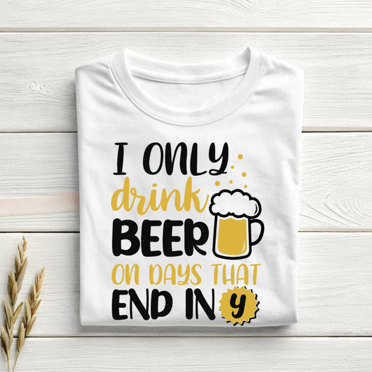 White t-shirt with humorous text and beer graphic on a wooden surface