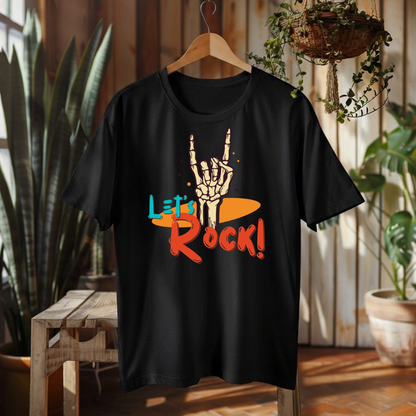 A black short-sleeve t-shirt hanging on a wooden hanger in a rustic indoor setting. The shirt features a graphic print of a skeleton hand making the rock on gesture over a yellow-orange surfboard, with the text 'Let's Rock!' in red and teal.