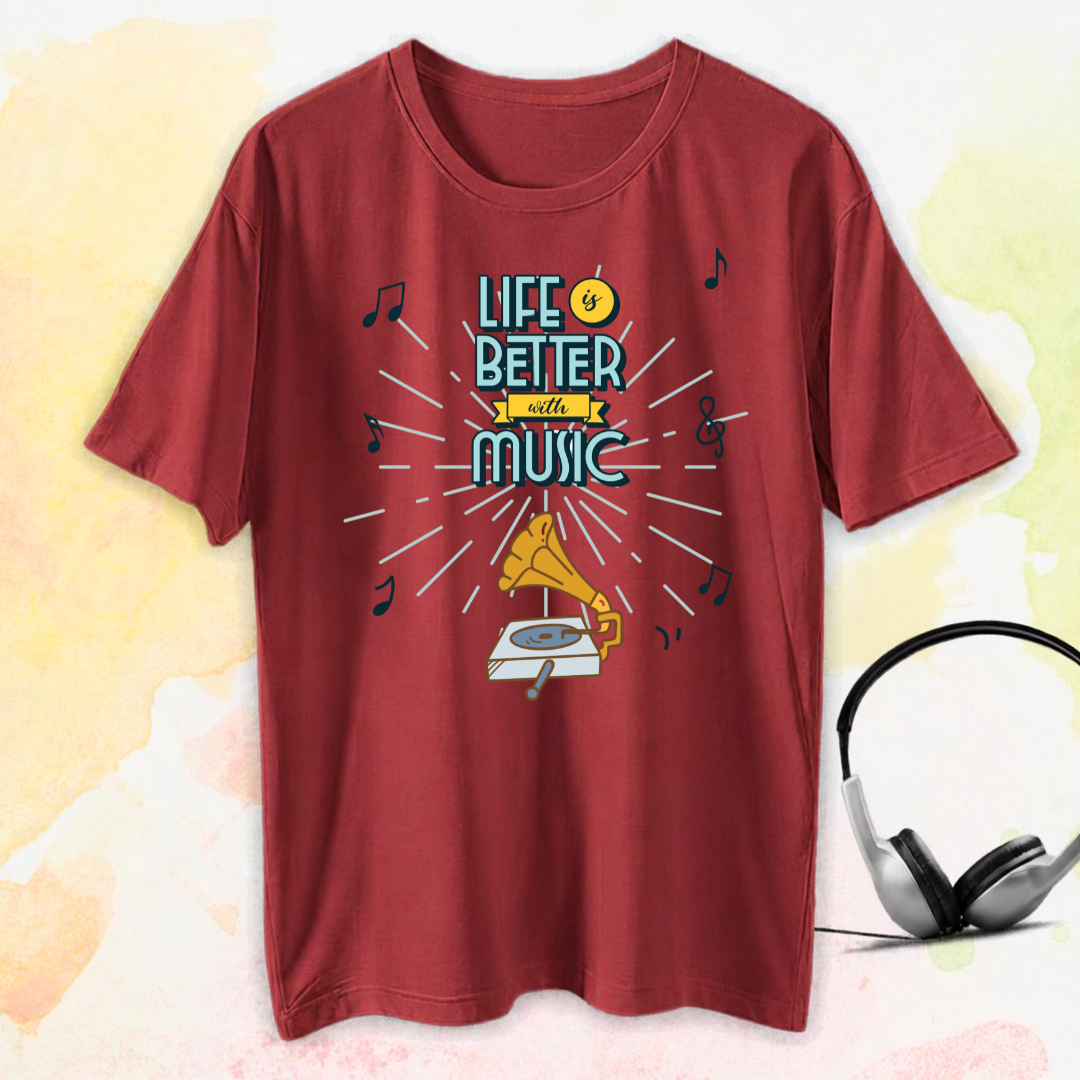 A red short-sleeve t-shirt with a retro music-themed graphic reading 'LIFE IS BETTER WITH MUSIC' in teal and yellow, surrounded by musical notes and a gramophone illustration. A pair of black and silver headphones is shown to the right as a styled prop on a light, textured background.