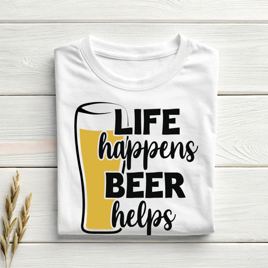White t-shirt with 'Life happens, Beer helps' text on a wooden surface