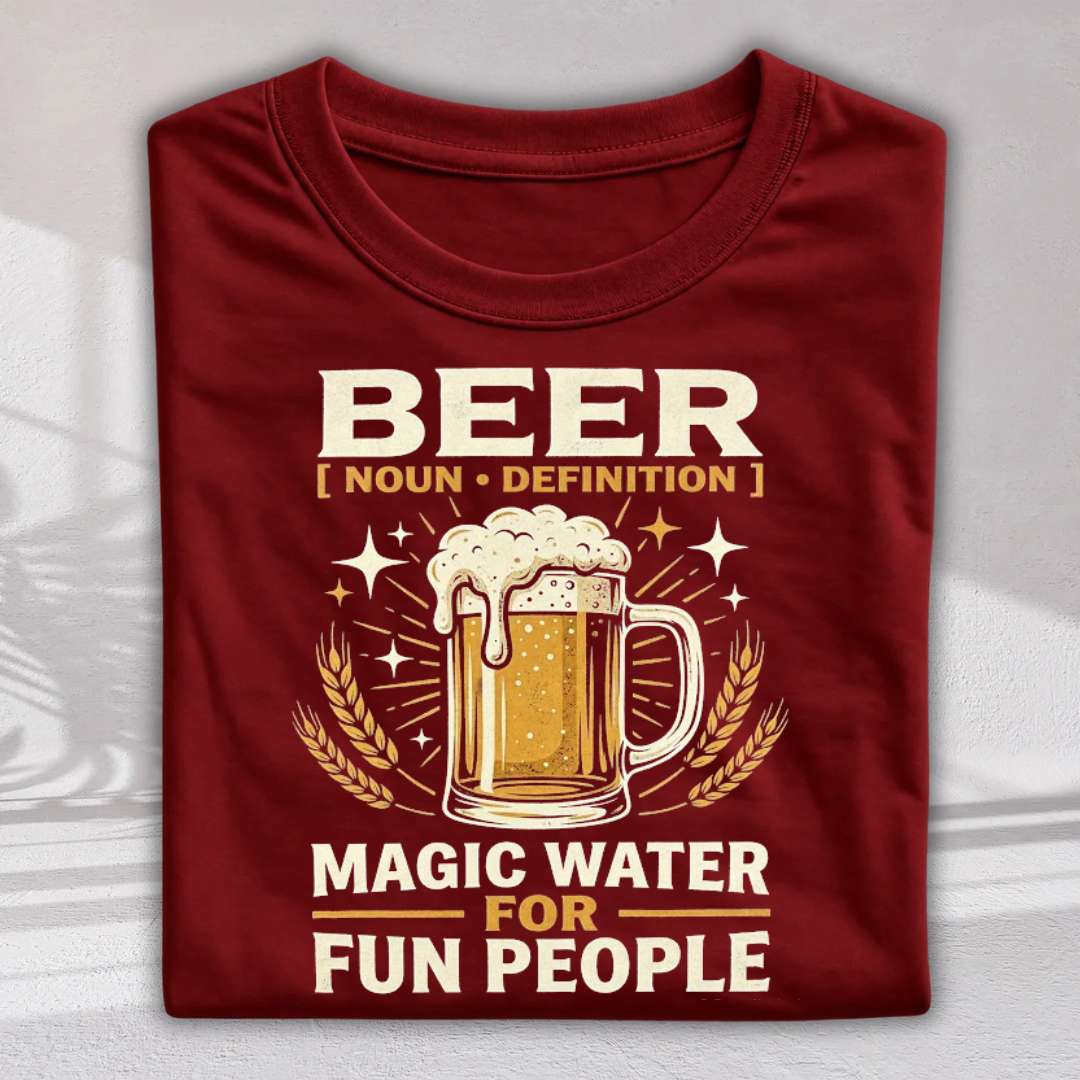 A folded maroon crewneck t-shirt with a graphic print featuring a beer mug, wheat stalks, and the text 'BEER [ NOUN • DEFINITION ] MAGIC WATER FOR FUN PEOPLE' in cream and gold lettering.