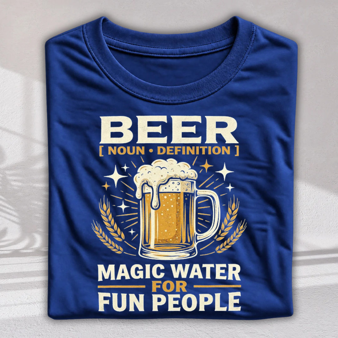 A folded royal blue t-shirt with a graphic print featuring a beer mug, wheat stalks, and the text 'BEER [ NOUN • DEFINITION ] MAGIC WATER FOR FUN PEOPLE' in white and gold lettering.