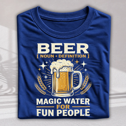 A folded royal blue t-shirt with a graphic print featuring a beer mug, wheat stalks, and the text 'BEER [ NOUN • DEFINITION ] MAGIC WATER FOR FUN PEOPLE' in white and gold lettering.