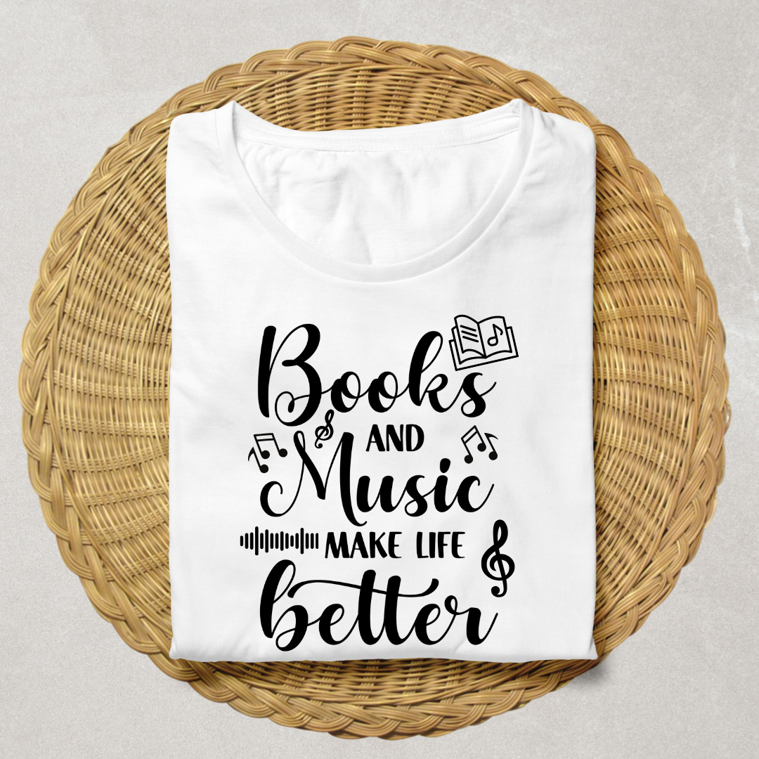 A folded white t-shirt with black text reading 'Books and Music MAKE LIFE better' decorated with musical notes and an open book graphic, displayed on a round woven wicker placemat over a light gray surface.