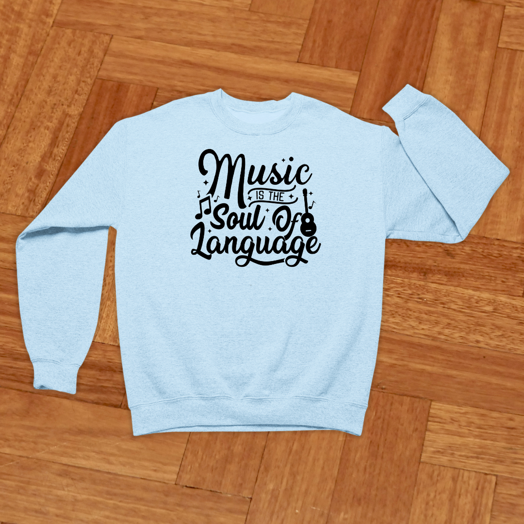 Light blue sweatshirt with 'Music is the Soul of Language' text on a wooden floor