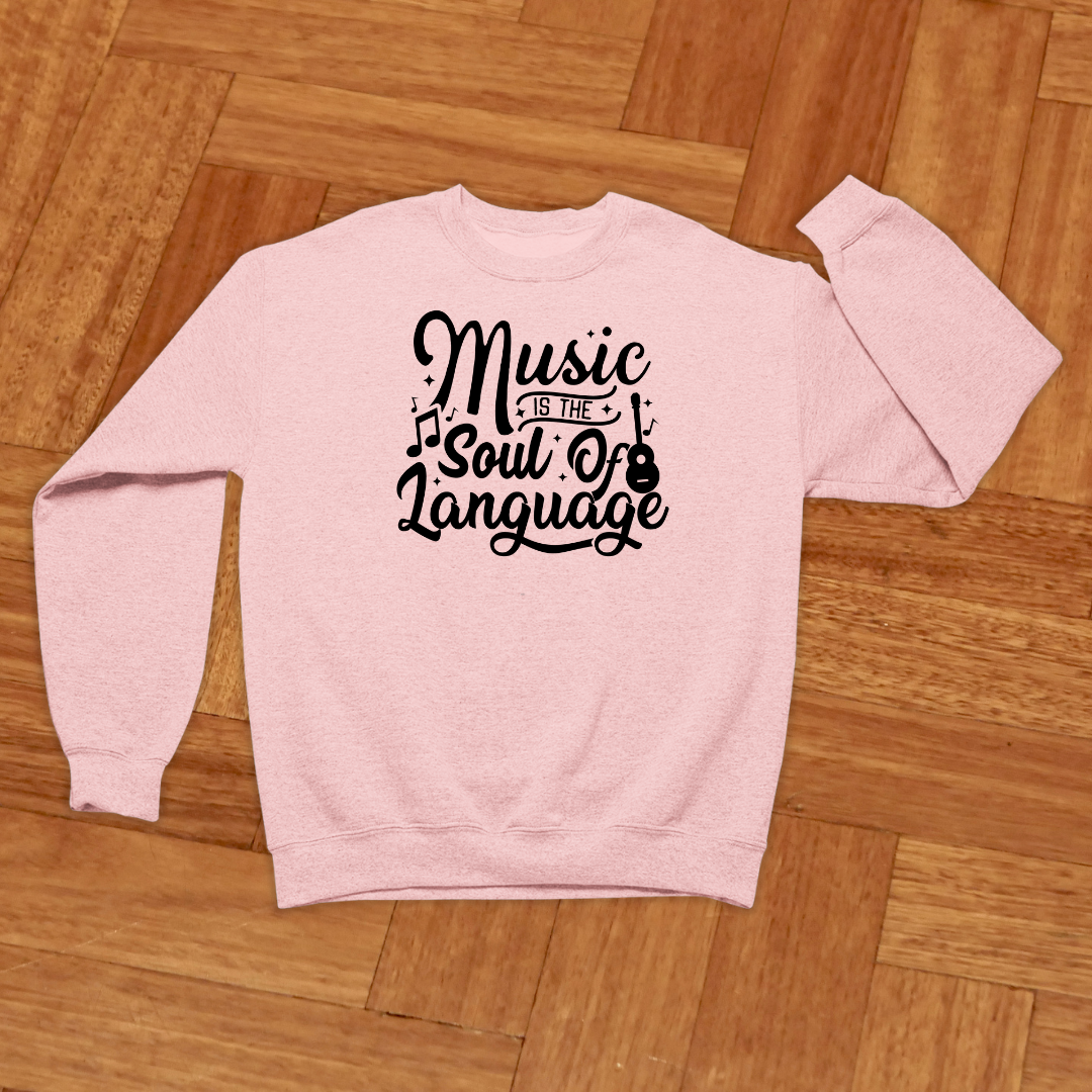 Pink sweatshirt with 'Music is the Soul of Language' text on a wooden floor