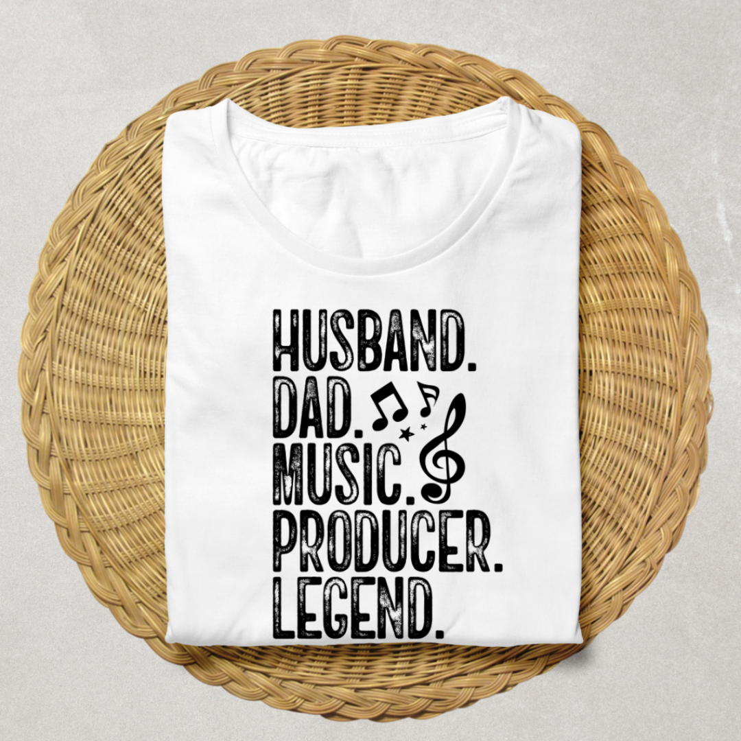 A folded white t-shirt with black text reading 'HUSBAND. DAD.'