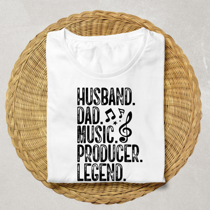 A folded white t-shirt with black text reading 'HUSBAND. DAD.'