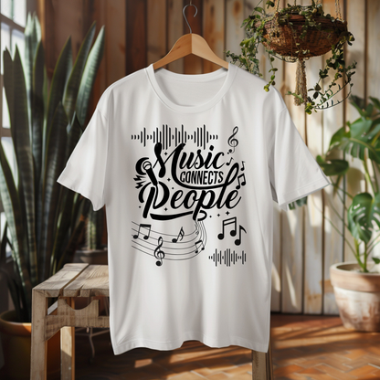 A white short-sleeve t-shirt hanging on a wooden hanger, featuring a black graphic print that reads 'Music Connects People' with musical notes and staff lines. The shirt is displayed in a warm, rustic indoor setting with wooden walls, potted plants, and a wooden bench.