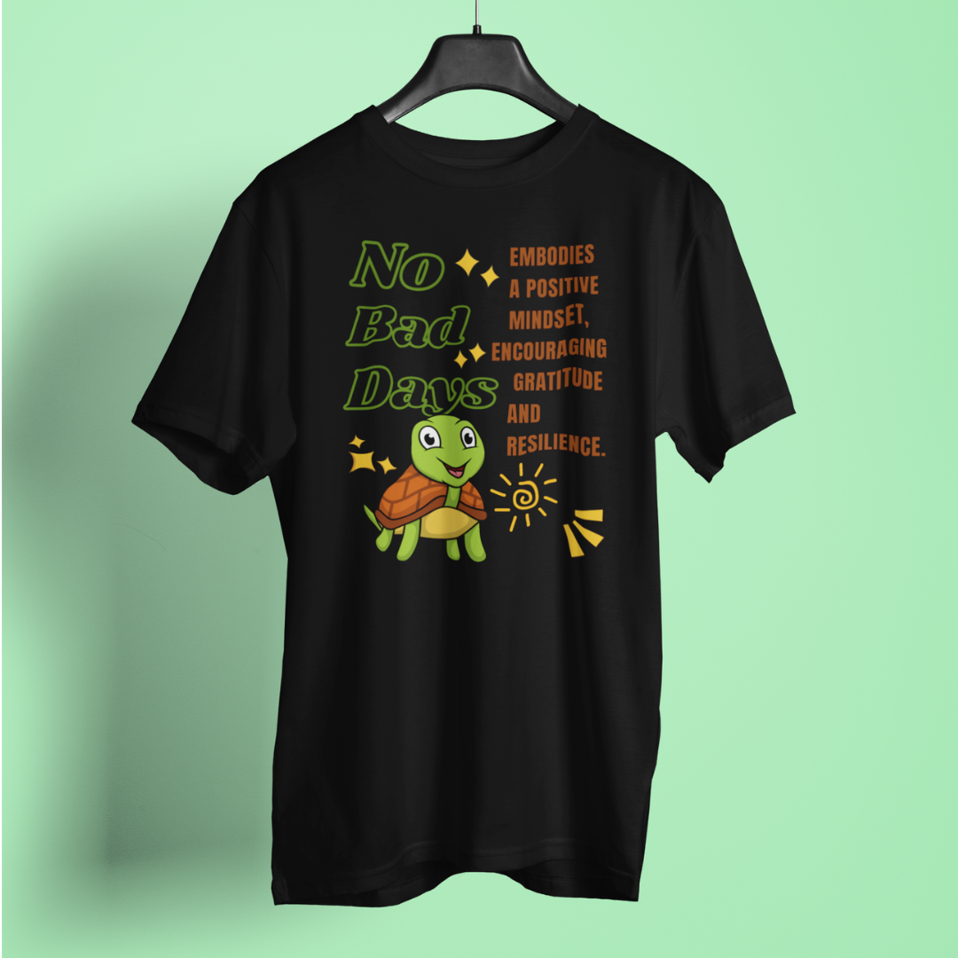 Black t-shirt with a turtle graphic and motivational text on a light green background