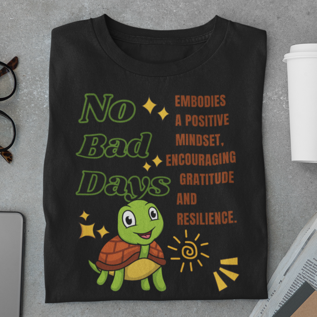 Black t-shirt with a turtle graphic and motivational text on a gray surface.